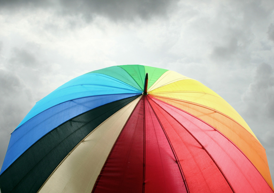 a colorful umbrella against a gray sky